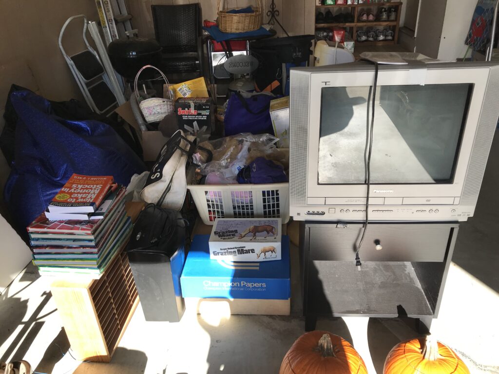 garage full of old discarded household items for donation by Cousins Hauling & Clean-out in Baltimore