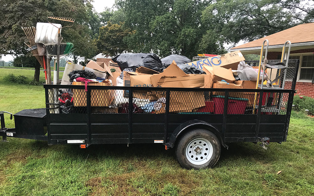 Trailer full of old boxes and bags of trash