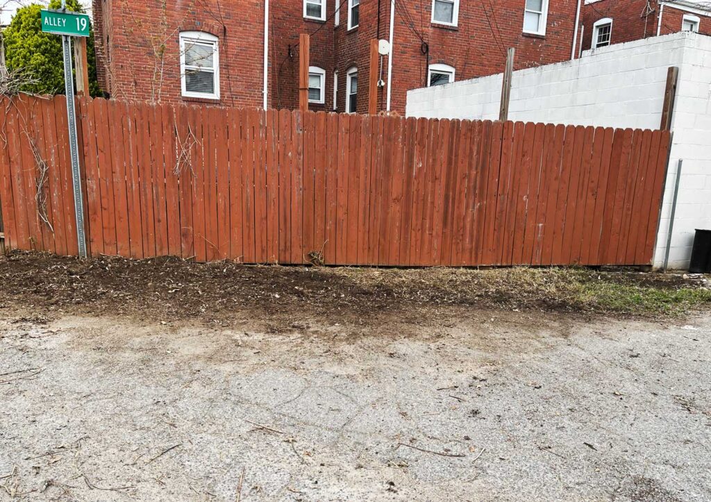 Alley with red fence and no junk